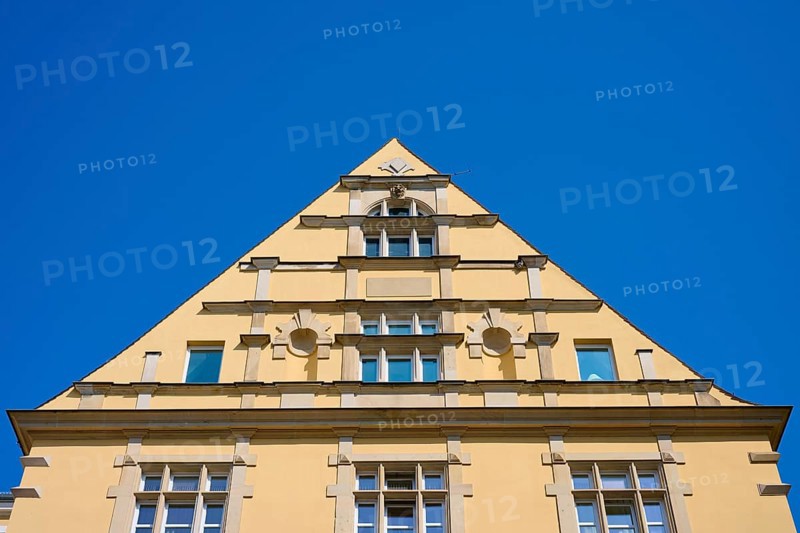 Building with striking triangular gable and windows against a clear sky, Regensburg, Bavaria, Germany