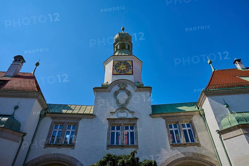 Historic building with tower and clock under a radiant sky. Baroque details and symmetrical design, brewhouse am Schloss, Regensburg, Bavaria, Germany