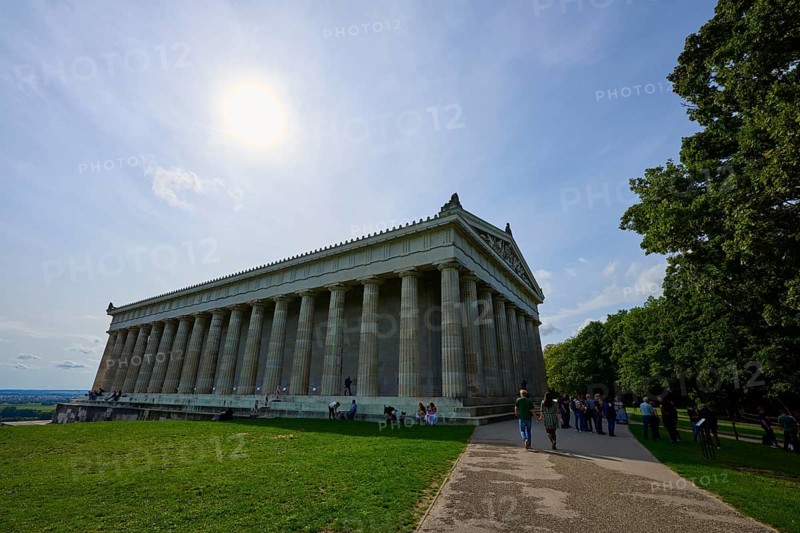 Photo of a historic columned building in sunny weather, surrounded by trees, Walhalla, Donaustauf, Regensburg, Bavaria, Germany