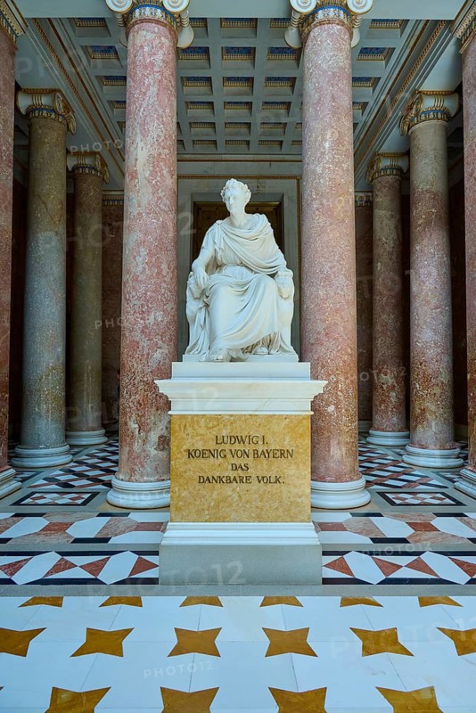 White statue of Ludwig I, surrounded by red marble columns and magnificent floor pattern, Walhalla, Donaustauf, Regensburg, Bavaria, Germany