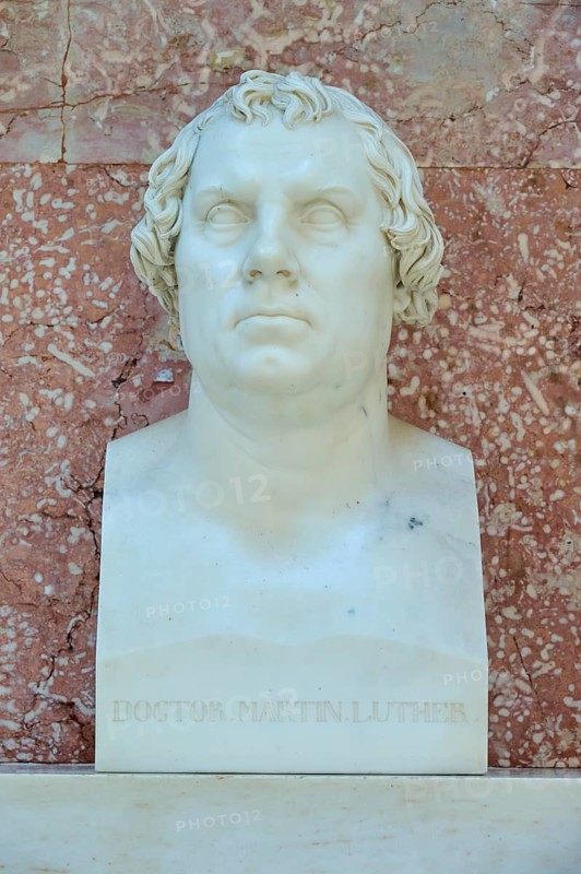 White marble bust of Martin Luther in front of a reddish wall, Walhalla, Donaustauf, Regensburg, Bavaria, Germany
