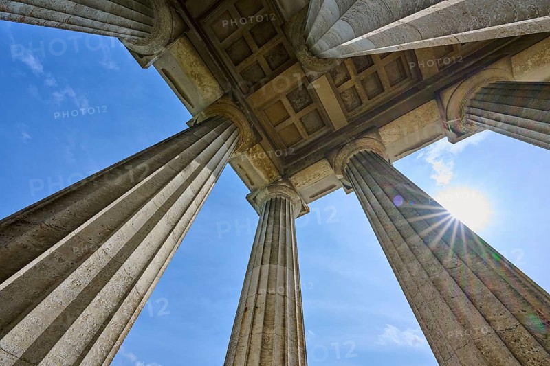 Imposing columns against a bright blue sky with a view of the sun, Walhalla, Donaustauf, Regensburg, Bavaria, Germany