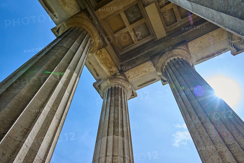 Three massive columns rise up against the blue sky, seen from below, Walhalla, Donaustauf, Regensburg, Bavaria, Germany
