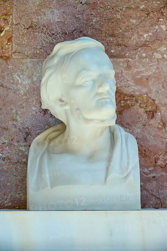 Artistic marble bust of Richard Wagner with an expressive face against a red background, Walhalla, Donaustauf, Regensburg, Bavaria, Germany