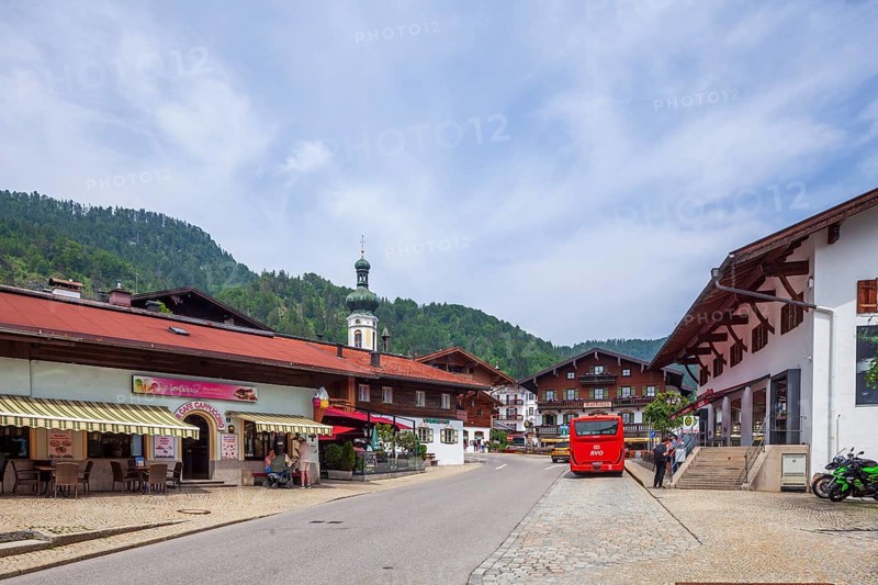 Village scene with houses, shops, bus, town hall and parish church St. Pankratius, Reit im Winkl, Chiemgau, Upper Bavaria, Bavaria, Germany