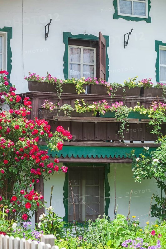 Balcony with flowers and flower boxes on an old house, Reit im Winkl, Chiemgau, Upper Bavaria, Bavaria, Germany