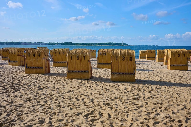 Row of numbered beach chairs under a blue sky on a sunny sandy beach, Heikendorf, Plön district, Kiel Fjord, Schleswig-Holstein, Germany