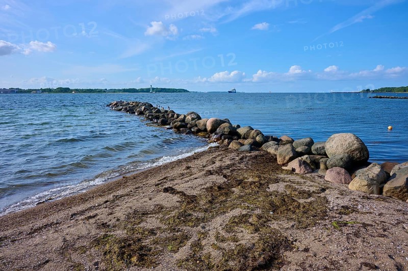 Stone breakwater in the sea on a sunny beach day with blue sky, Heikendorf, Plön district, Kiel Fjord, Schleswig-Holstein, Germany