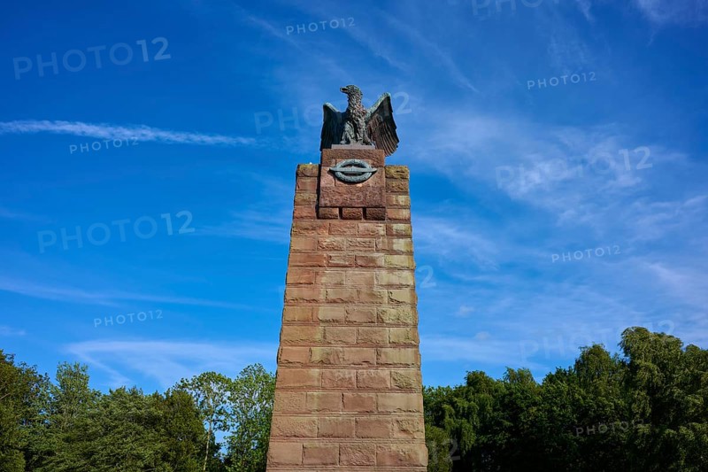 Massive stone monument with eagle, under a bright blue sky. Impression of grandeur and freedom in the midst of nature, submarine memorial, Heikendorf, Plön district, Kiel Fjord, Schleswig-Holstein, Germany