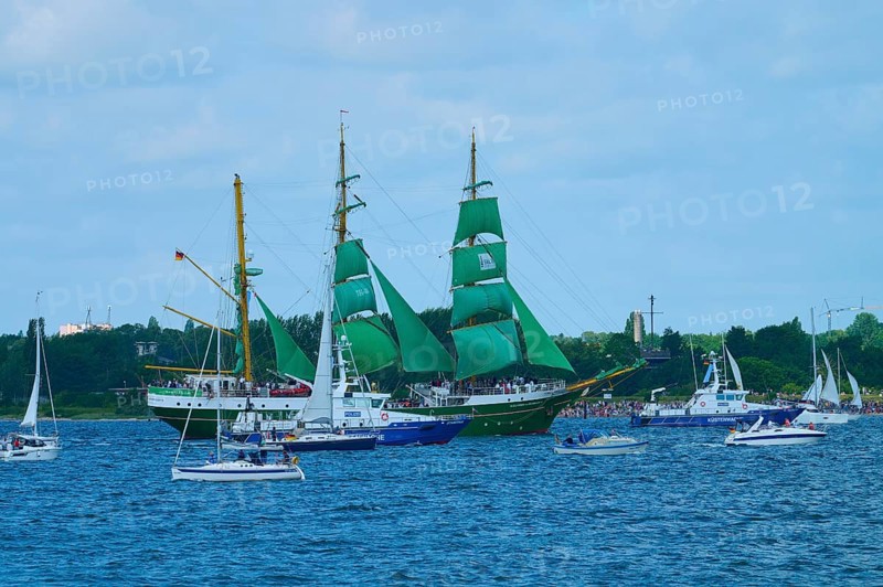 A large sailing ship with green sails Alexander von Humbold 2 and other boats on blue water, Windjammer Parade Kiel 2025, Heikendorf, Plön district, Kiel Fjord, Schleswig-Holstein, Germany