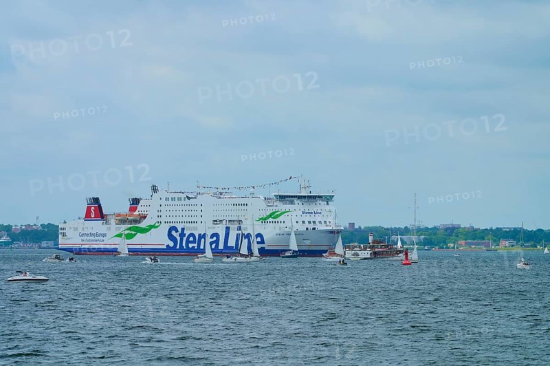 Large Stena Line ferry on the sea, surrounded by smaller sailing boats under a cloudy sky, Windjammer Parade Kiel 2025, Heikendorf, Kreis Plön, Kieler Förde, Schleswig-Holstein, Germany