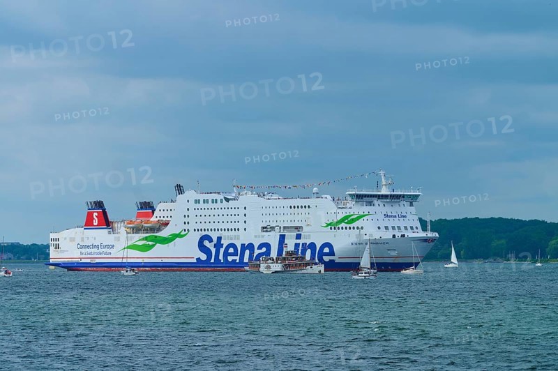 Stena Line ferry surrounded by sailing boats on the sea under a cloudy sky, Windjammer Parade Kiel 2025, Heikendorf, Kreis Plön, Kieler Förde, Schleswig-Holstein, Germany