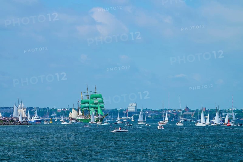 Green tall ship Alexander von Humbold 2 among many boats near a town, Windjammer Parade Kiel 2025, Heikendorf, Plön district, Kiel Fjord, Schleswig-Holstein, Germany