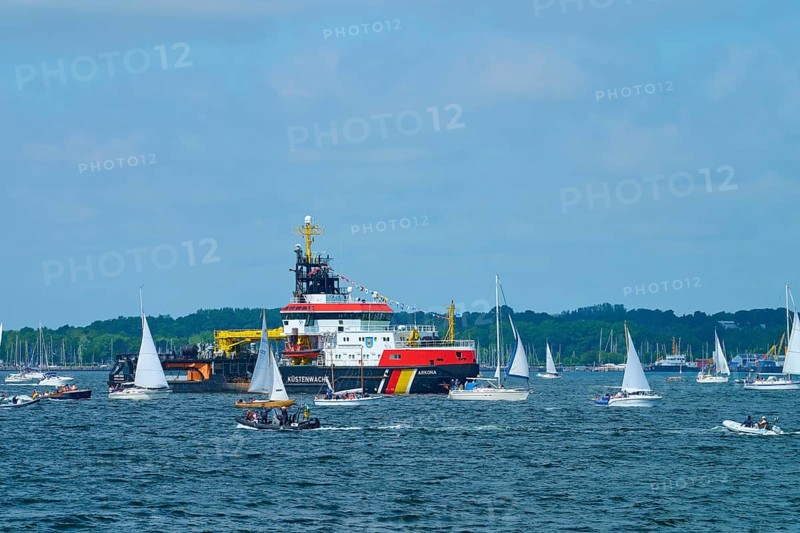 Various sailing boats and a large ship Arkona Coast Guard on a sunlit sea, Windjammer Parade Kiel 2025, Heikendorf, Plön district, Kiel Fjord, Schleswig-Holstein, Germany