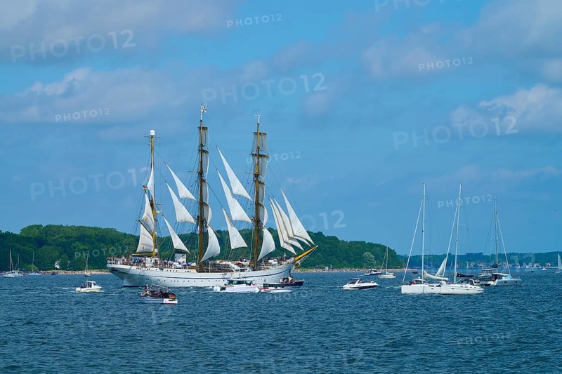 An impressive tall ship Gorch Fock with other boats on a sunny sea, Windjammer Parade Kiel 2025, Heikendorf, Kreis Plön, Kieler Förde, Schleswig-Holstein, Germany