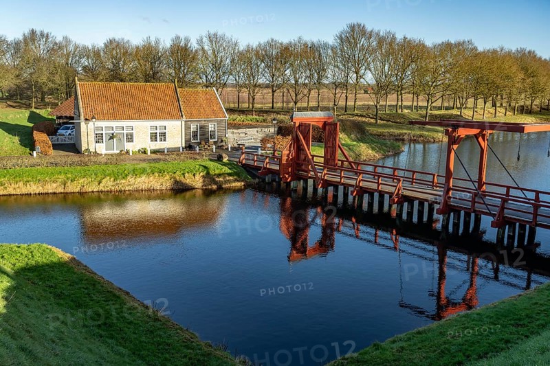 Moat and drawbridge of the inhabited former Bourtange fortress, Groningen, Netherlands