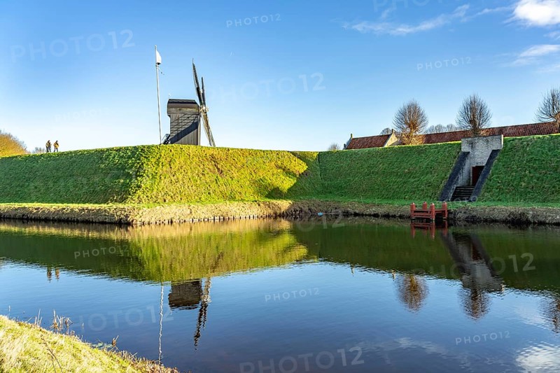 Moat and trestle windmill of the inhabited former fortress of Bourtange, Groningen, Netherlands