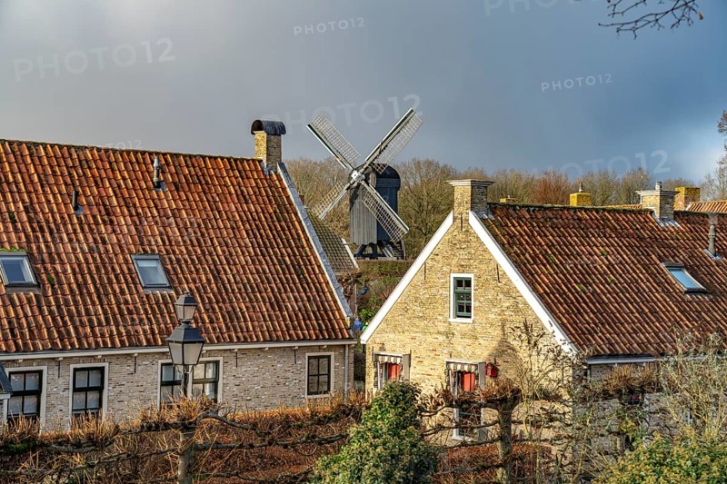 Traditional houses and windmill of the inhabited former fortress of Bourtange, Groningen, Netherlands