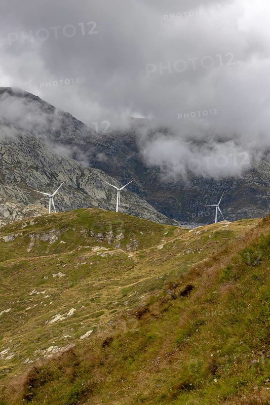 Wind turbines on the Gotthard Pass in the clouds, view from Passo Scimfuss, Airolo, Ticino, Switzerland