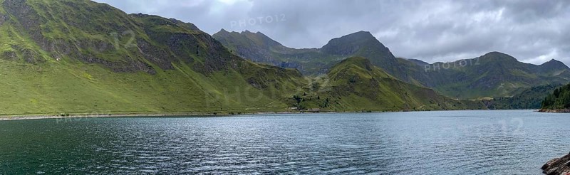 Lago Ritom panorama, right Passo del Sole and Passo dell'Uomo, left road on the lakeshore, Airolo, Ticino, Switzerland