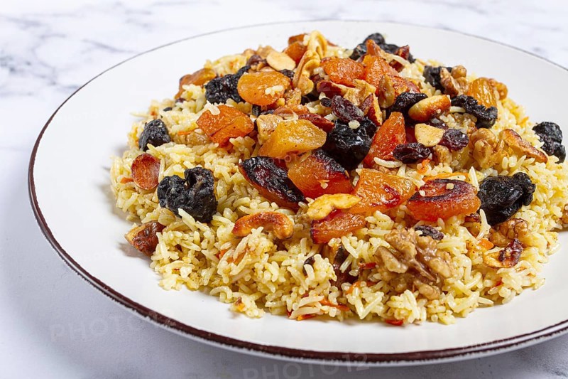 Rice dish, with the addition of dried fruits, nuts and spices of Middle Eastern cuisine, homemade, no people