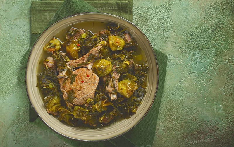 Chakapuli, Georgian dish, stewed meat with herbs and tkemali, in white wine, homemade, no people