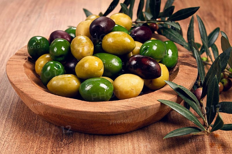A mixture of olives, varieties of chalkidiki, Verdi giganti and Kalamata, in a bowl, top view, no people