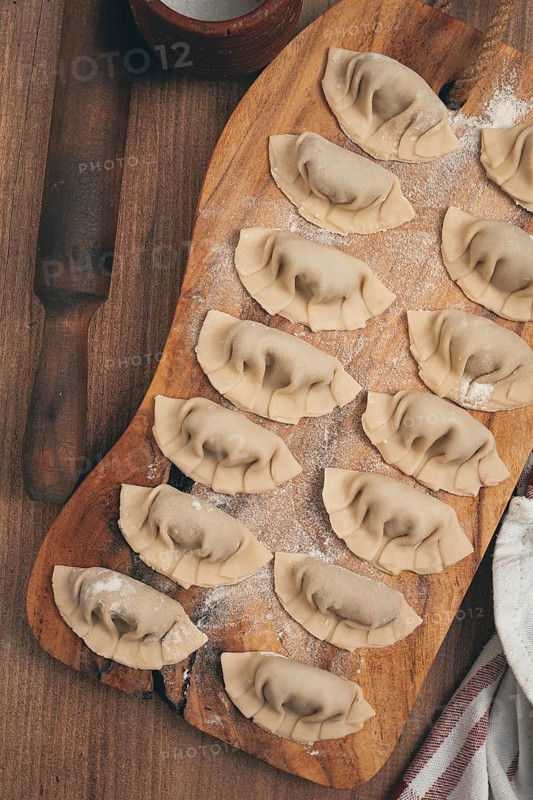 Gyoza cooking, on a cutting board, gyoza Japanese dumplings, top view, selective processing, raw gyoza