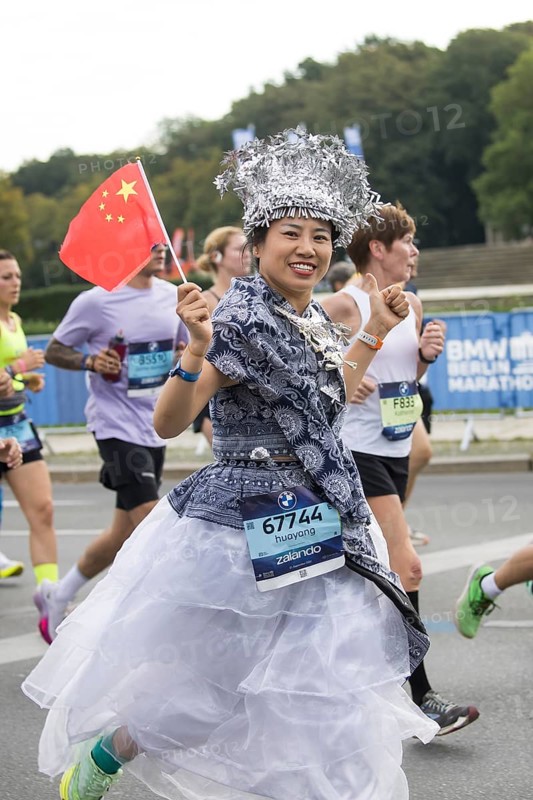 A runner with the flag of the People's Republic of China on the Great Star at the 51st BMW Berlin Marathon 2025 on 21 September 2025