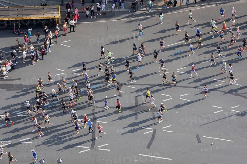Runners with long shadows on the big star seen from the Victory Column at the 51st BMW Berlin Marathon 2025 on 21 September 2025