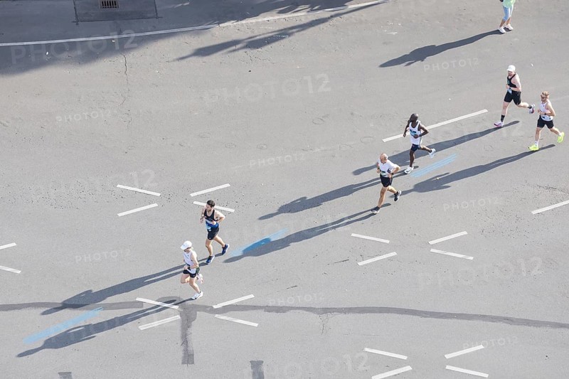 Runners with long shadows on the big star seen from the Victory Column at the 51st BMW Berlin Marathon 2025 on 21 September 2025