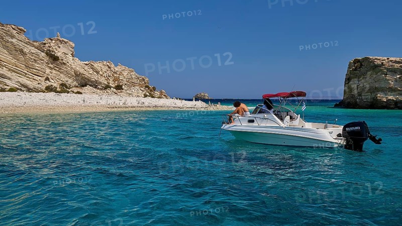 Motorboat drifting in the clear blue sea in front of a rocky coastline, White Cliffs, White Beach, Makri Aspronisi Island, Natura 2000 area, boat trip, Aspronisi, Lipsi, Dodecanese, Greek Islands, Greece