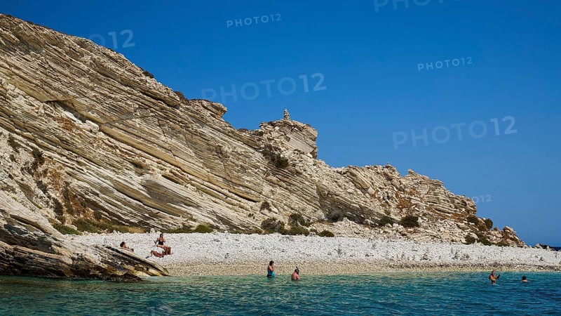 Rocky coast with people walking along the beach and swimming in the sea, White Cliffs, White Beach, Makri Aspronisi Island, Natura 2000 area, Boat trip, Aspronisi, Lipsi, Dodecanese, Greek Islands, Greece