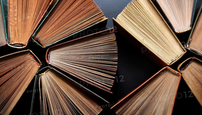 Old books arranged highlighting their historical significance. Neatly arranged representing a collection of wisdom, AI generated