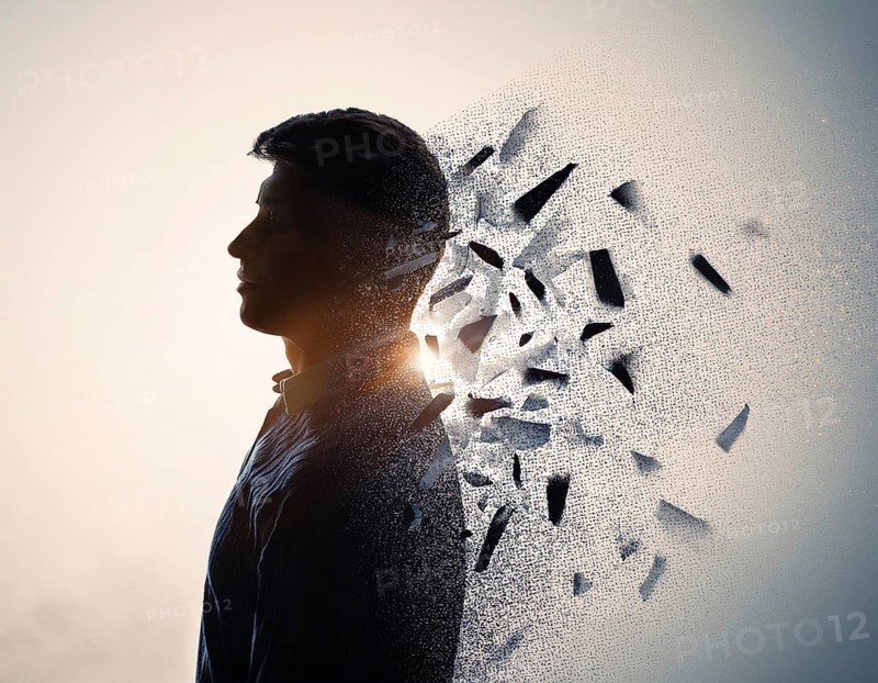 Creative image showing a silhouette of a man merging with an abstract dispersion effect and dramatic light, symbolizing transformation, disintegration, creativity, and inspiration with a focus on artistic exploration, AI generated