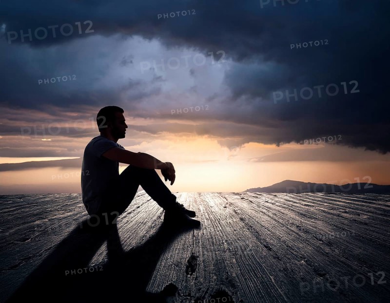 Silhouette of a person sitting alone within a brick archway, observing a peaceful and scenic cloudy horizon, evoking feelings of solitude, introspection, and calmness, AI generated