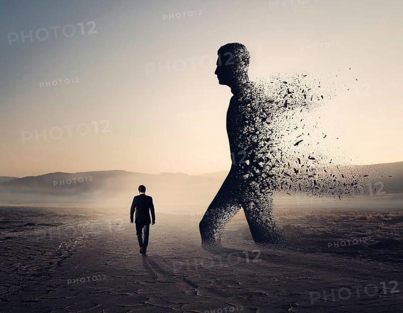 Creative image showing a silhouette of a man merging with an abstract dispersion effect and dramatic light, symbolizing transformation, disintegration, creativity, and inspiration with a focus on artistic exploration, AI generated