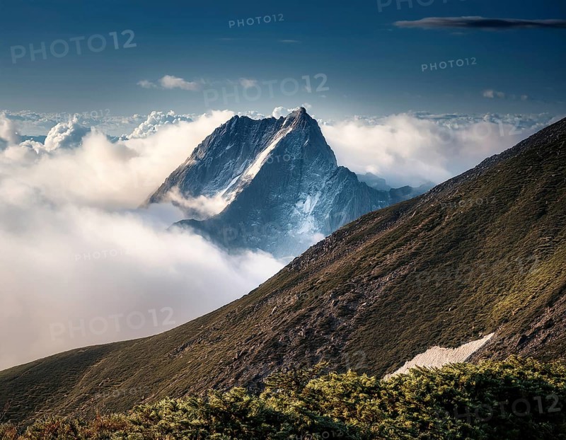 A stunning view of a snowy mountain peak rising above the clouds, with a blue sky background. Capturing a tranquil moment in nature's beauty, evoking feelings of serenity and wonder, AI generated