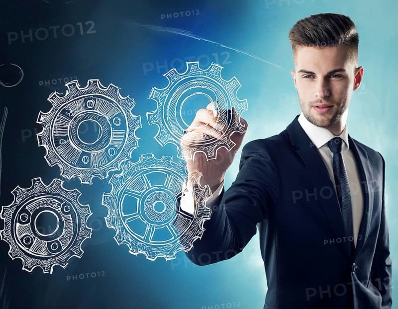 Businessman in formal attire holding stylized metallic gears against a blue futuristic background. Represents teamwork, strategy, and technological innovation. Ideal for connections, business operations, and industrial concepts, AI generated