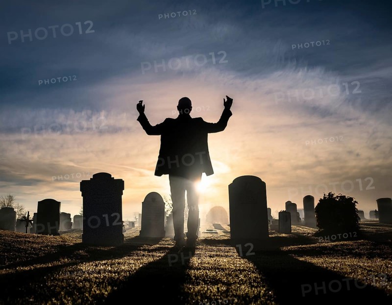 A silhouette of a lone figure walking off a gravestone, The scene evokes Resurrection thoughts emotional depth, AI generated