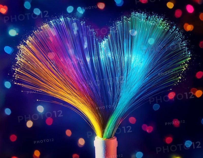 Colorful artistic display featuring vibrant light patterns shaped like a heart, expressing love and creativity through illuminated fibers in a mesmerizing spectrum of rainbow hues, AI generated