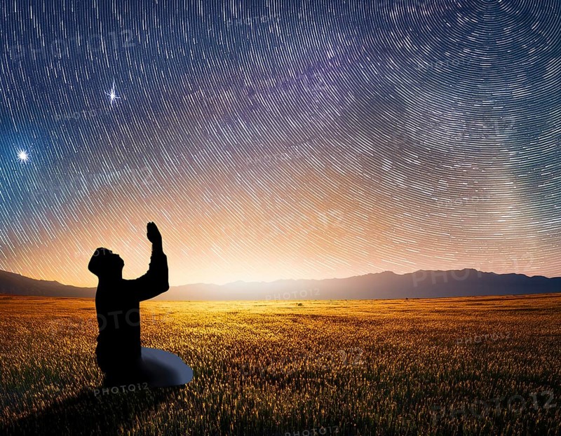 A man kneels in peaceful reflection under the vibrant Milky Way galaxy at sunset in an open natural setting, making prays, AI generated