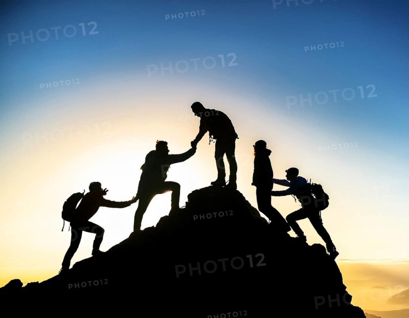 A dynamic depiction of teamwork and determination, climbers ascend a rugged mountain peak during sunset, silhouetted against a vibrant, colorful sky, AI generated