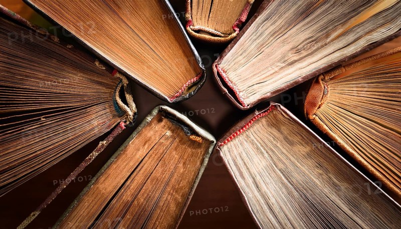 Old books arranged highlighting their historical significance. Neatly arranged representing a collection of wisdom, AI generated