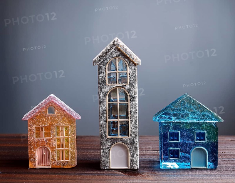 A collection of small glass model houses with cozy lighting, creating a warm and inviting atmosphere, AI generated