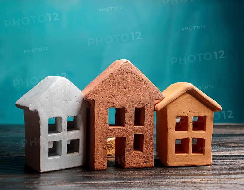 A collection of small model houses with cozy lighting, creating a warm and inviting atmosphere, AI generated