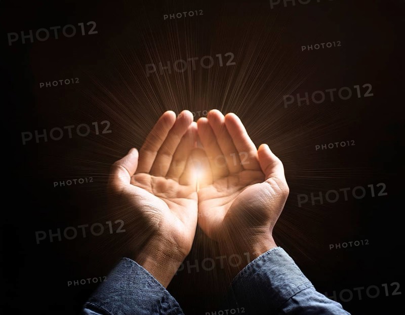 Image of open hands embracing a radiant light source, embodying concepts of hope, spirituality, and inspiration. Features strong symbolism and evocative atmosphere for spiritual, motivational, or artistic themes, AI generated