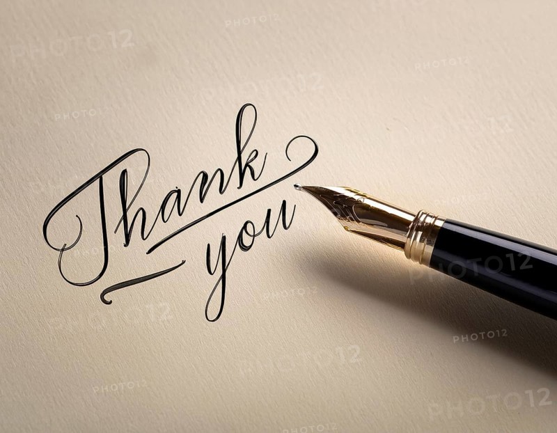 Elegant pen rests alongside a handwritten Thank You card on a wooden surface in soft light. Emphasizing gratitude, personal touch, and communication through traditional methods, AI generated