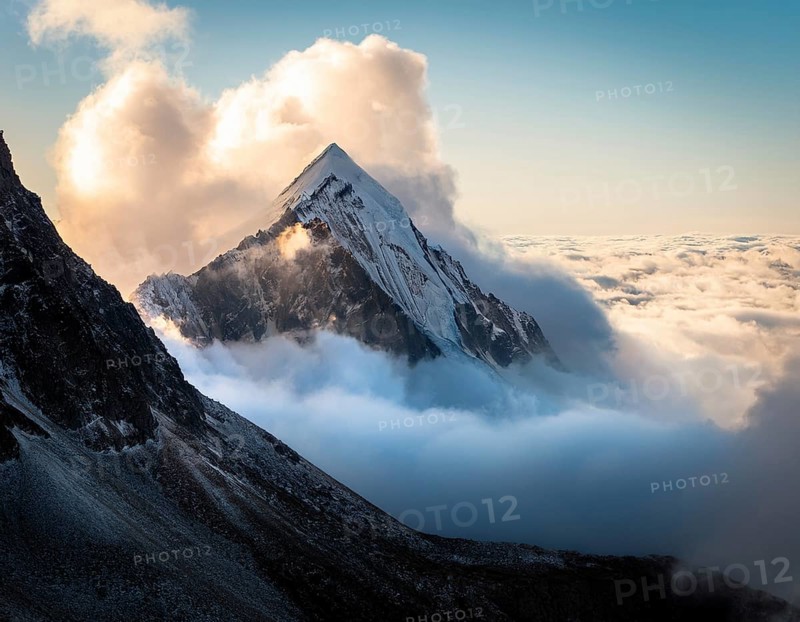 A stunning view of a snowy mountain peak rising above the clouds, with a blue sky background. Capturing a tranquil moment in nature's beauty, evoking feelings of serenity and wonder, AI generated