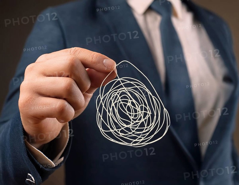 A close-up of a professional ipresenting a piece of intricate, tangled wire, symbolizing complexity, solution-finding, and creative problem-solving in a business or conceptual context, AI generated